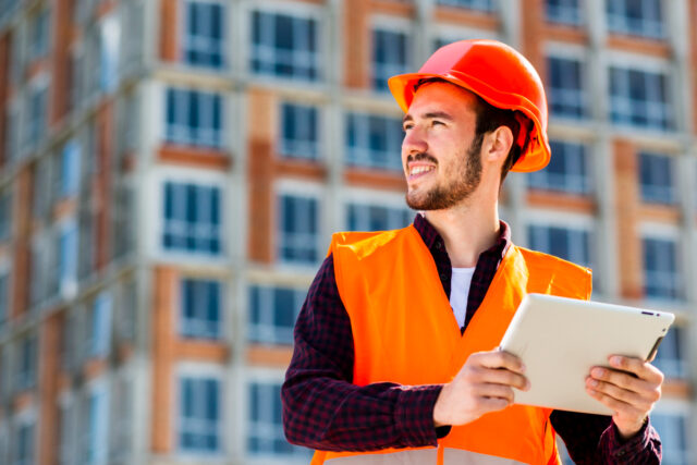 Imagem de um engenheiro fazendo a gestão de obras com ajuda de um tablet